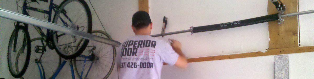 Specialist repairing garage door spring