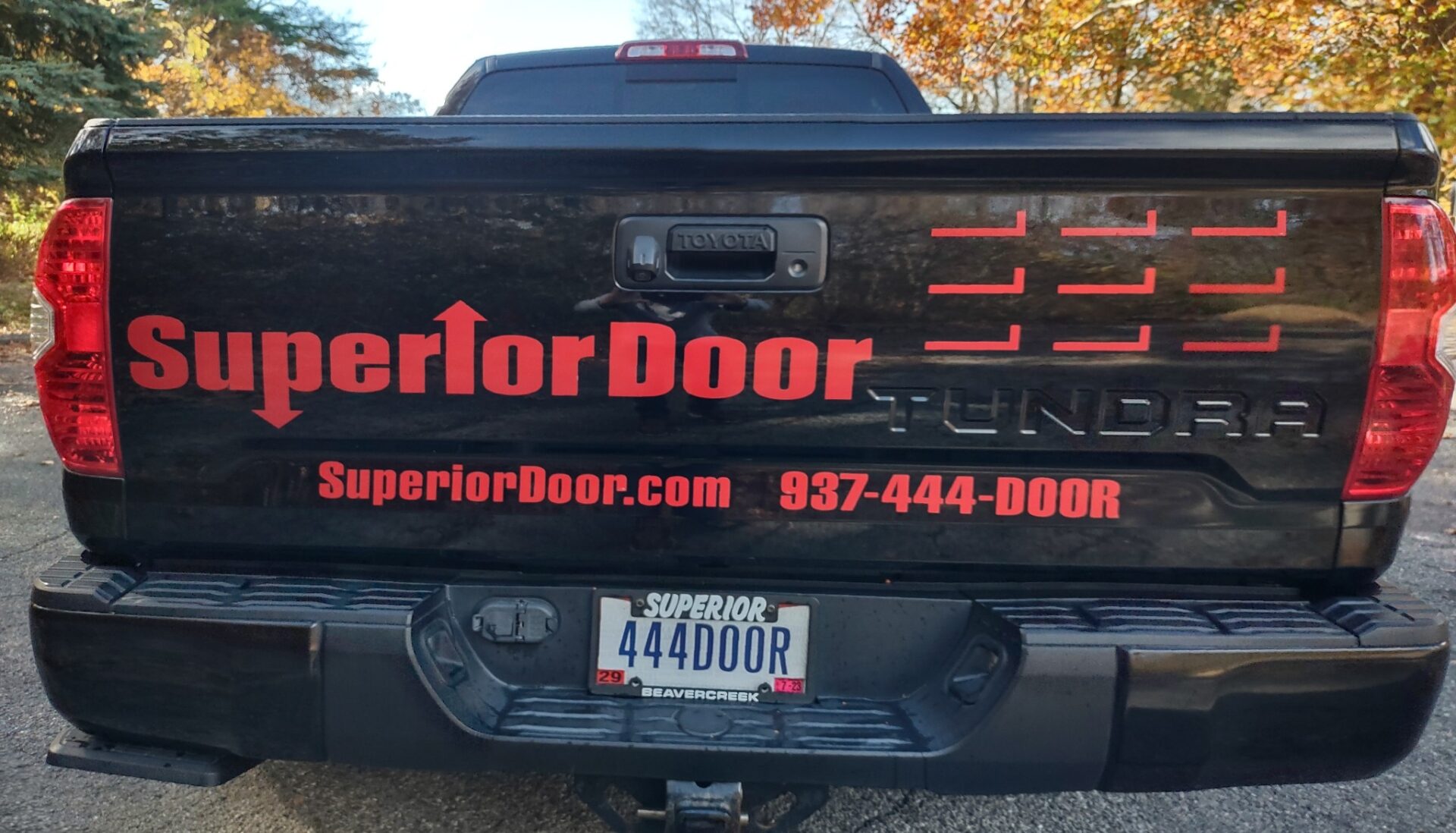 Truck tailgate with Superior Door branding and a distinctive license plate.
